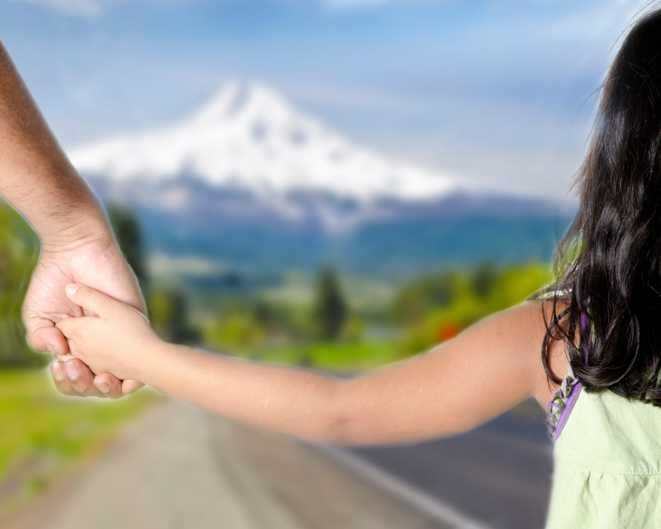 A young Native American girl gazes at Mount Hood in Portland, symbolizing the connection between Indigenous communities and the land.